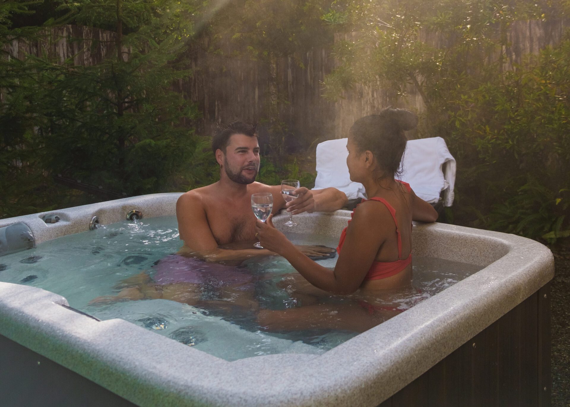 Couple Relaxing in Forest Hot Tub
